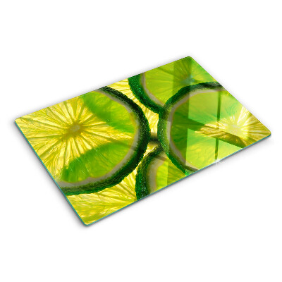 Planche à découper en verre Tranches de citron vert sur fond vert