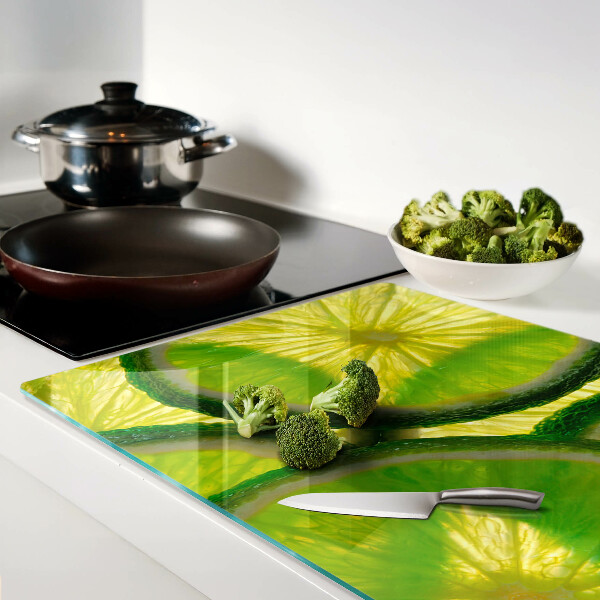 Planche à découper en verre Tranches de citron vert sur fond vert