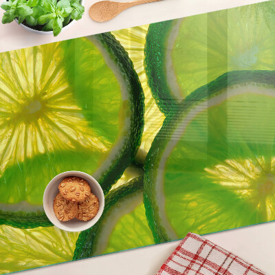 Planche à découper en verre Tranches de citron vert sur fond vert