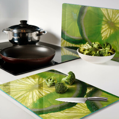 Planche à découper en verre Tranches de citron vert sur fond vert