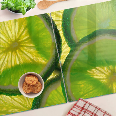 Planche à découper en verre Tranches de citron vert sur fond vert