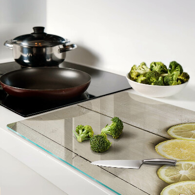 Planche à découper verre Tranches de citron sur fond de bois