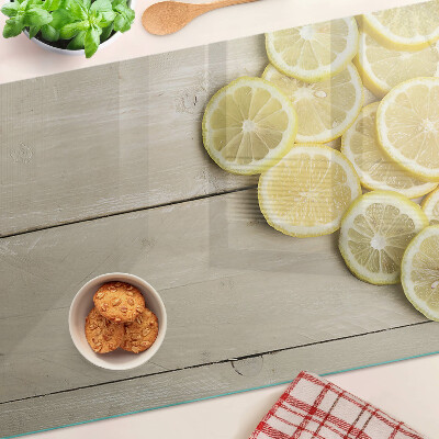 Planche à découper verre Tranches de citron sur fond de bois