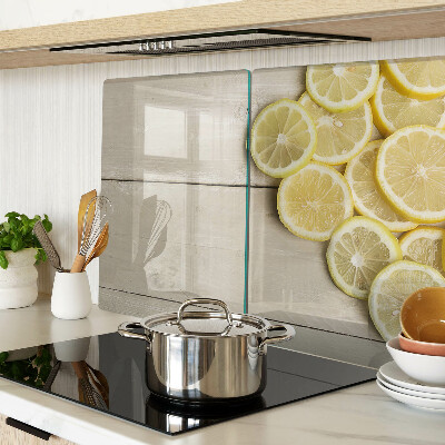 Planche à découper verre Tranches de citron sur fond de bois
