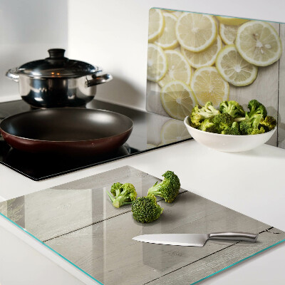 Planche à découper verre Tranches de citron sur fond de bois