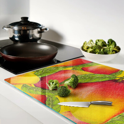 Planche à découper en verre Poivrons sur fond de feuilles vertes