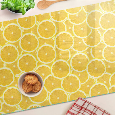 Planche à découper en verre Tranches de citron sur fond jaune