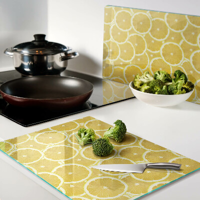 Planche à découper en verre Tranches de citron sur fond jaune