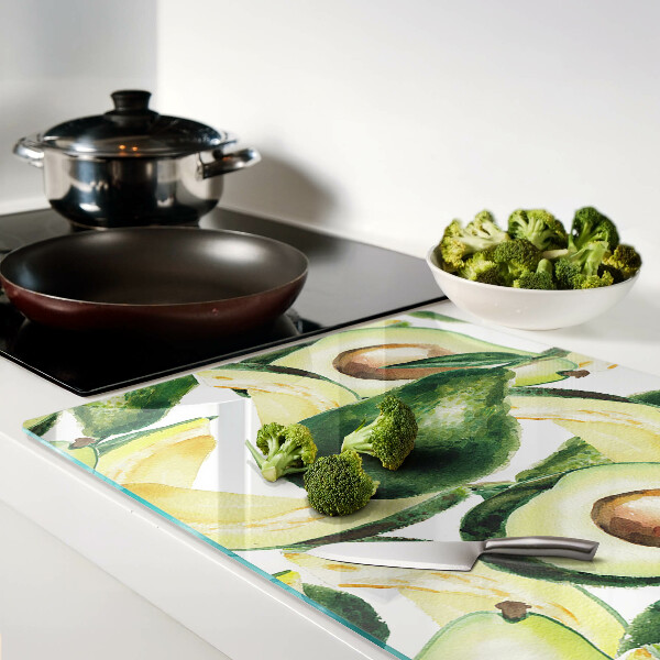 Planche à découper verre Avocat avec des feuilles en arrière-plan