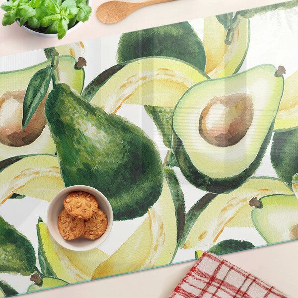 Planche à découper verre Avocat avec des feuilles en arrière-plan