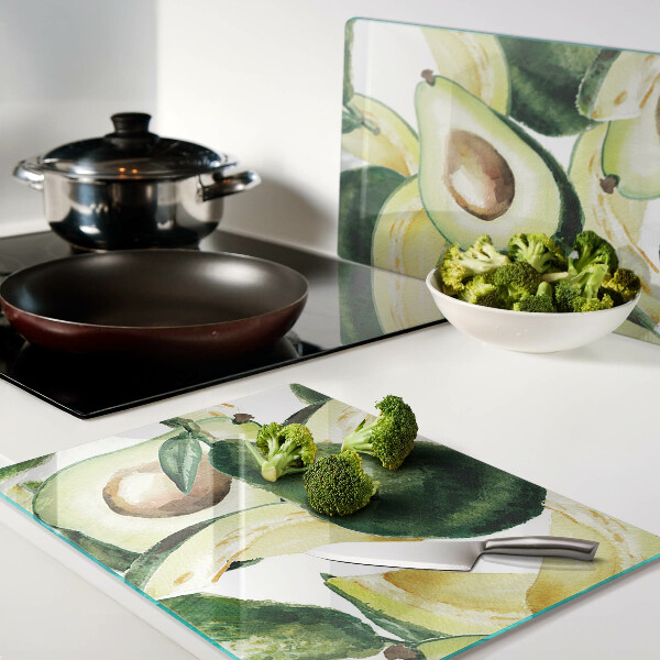 Planche à découper verre Avocat avec des feuilles en arrière-plan