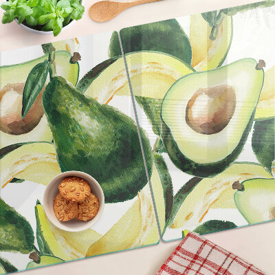 Planche à découper verre Avocat avec des feuilles en arrière-plan