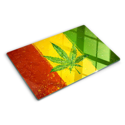 Planche à découper verre Feuille de cannabis sur fond coloré