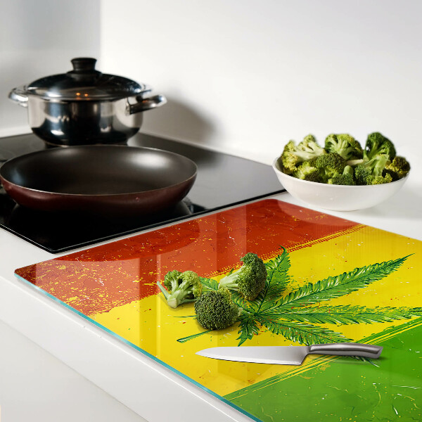 Planche à découper verre Feuille de cannabis sur fond coloré