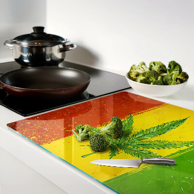 Planche à découper verre Feuille de cannabis sur fond coloré