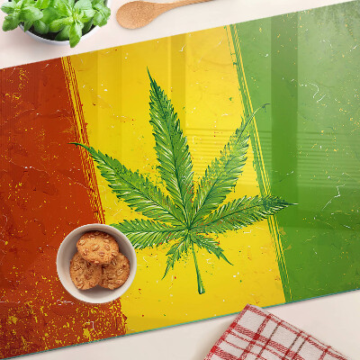 Planche à découper verre Feuille de cannabis sur fond coloré