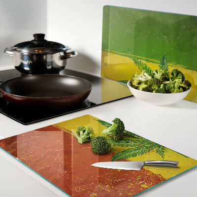 Planche à découper verre Feuille de cannabis sur fond coloré
