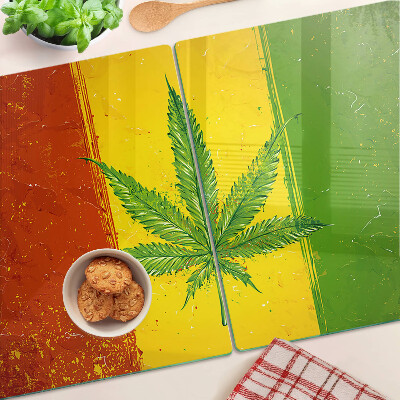 Planche à découper verre Feuille de cannabis sur fond coloré