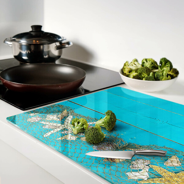 Planche à découper verre Coquillages et étoiles de mer dans un filet