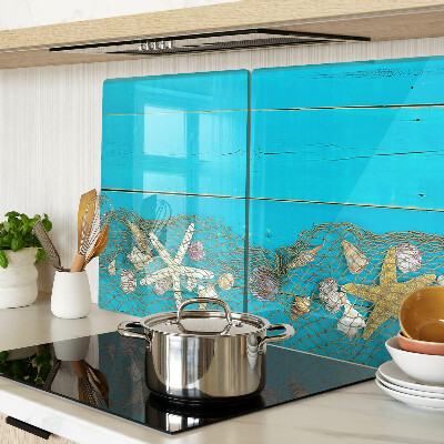 Planche à découper verre Coquillages et étoiles de mer dans un filet
