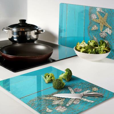 Planche à découper verre Coquillages et étoiles de mer dans un filet
