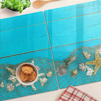 Planche à découper verre Coquillages et étoiles de mer dans un filet