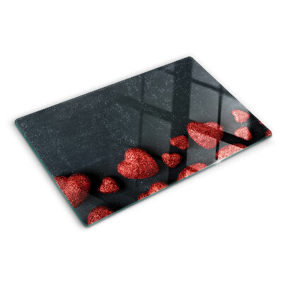 Planche à découper en verre Coeurs rouges sur fond sombre