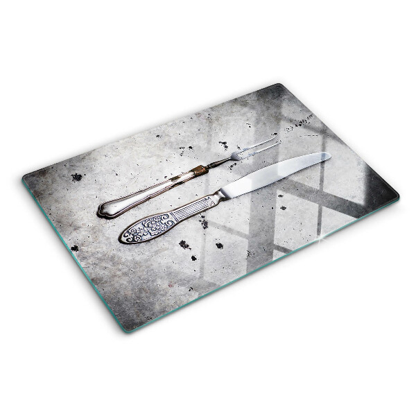Planche à découper en verre Couverts sur fond de béton