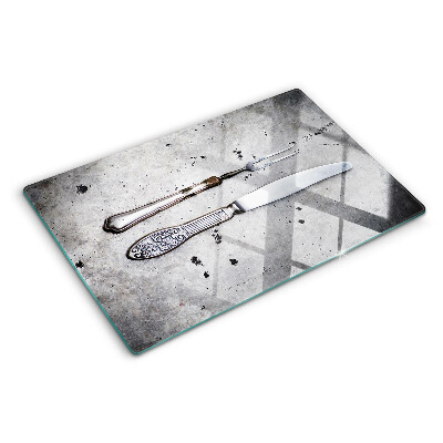 Planche à découper en verre Couverts sur fond de béton
