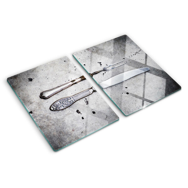Planche à découper en verre Couverts sur fond de béton