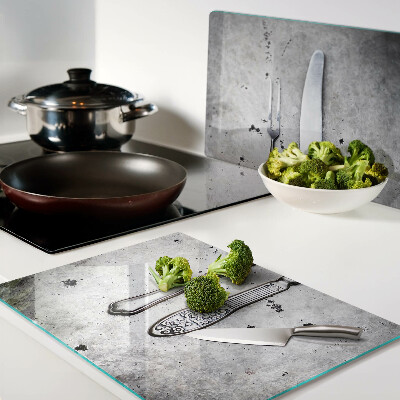 Planche à découper en verre Couverts sur fond de béton