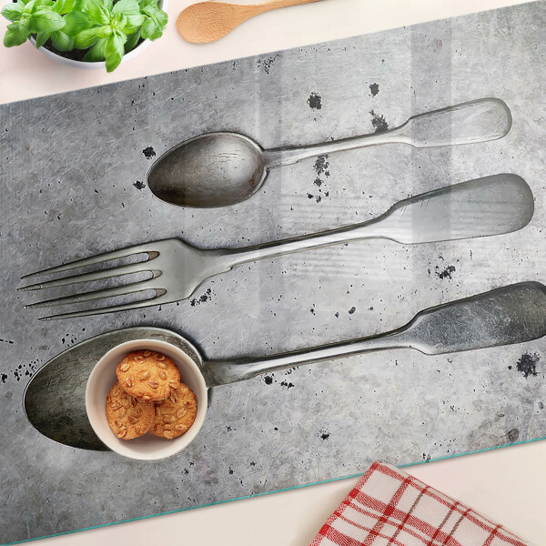 Planche à découper verre Couverts sur fond de béton