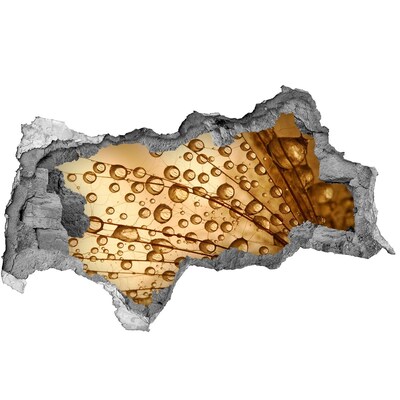 Sticker mural effet trou 3d Une goutte dorée sur fond de béton