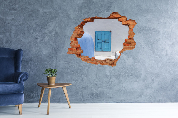 Sticker mural effet trou Un mur délabré avec une porte bleue