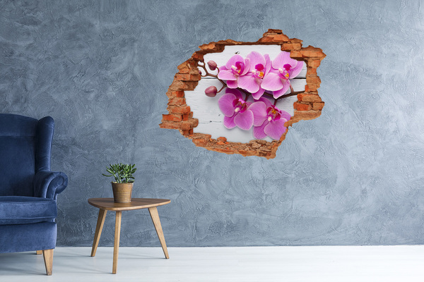Sticker mural effet trou Des orchidées fleurissent à travers un trou dans le mur