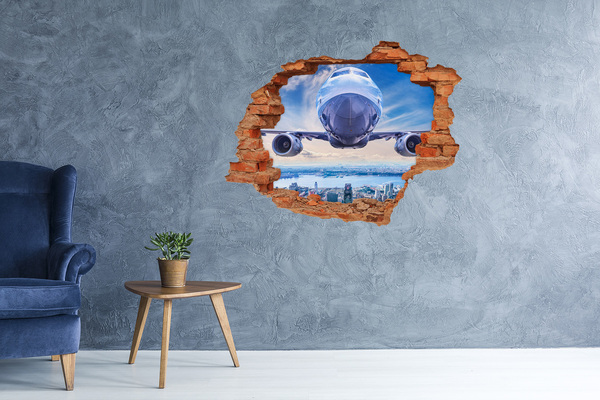 Sticker mural effet trou Un avion survole la ville