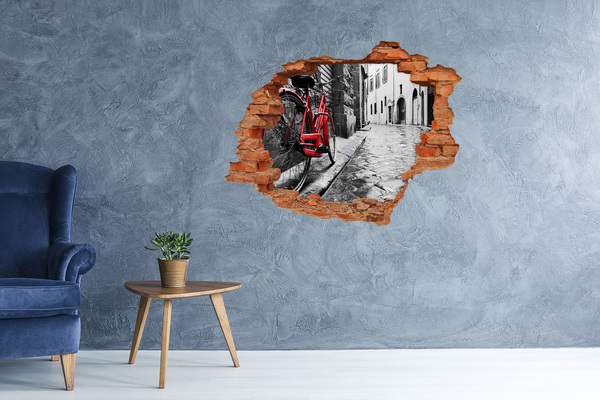 Sticker trou dans le mur Un vélo rouge dans une rue charmante
