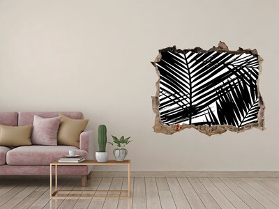Sticker trou dans le mur Des feuilles tropicales dans un trou dans le mur