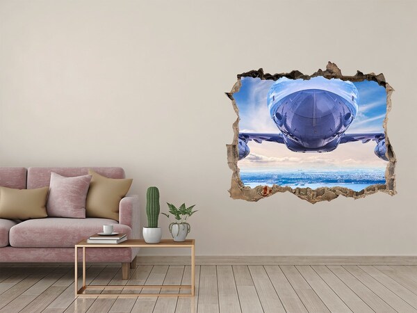 Sticker mural effet trou Un avion survole la ville