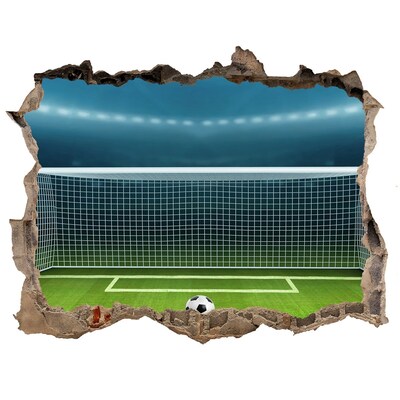 Autocollant mural trou Le stade de football derrière le trou dans le mur