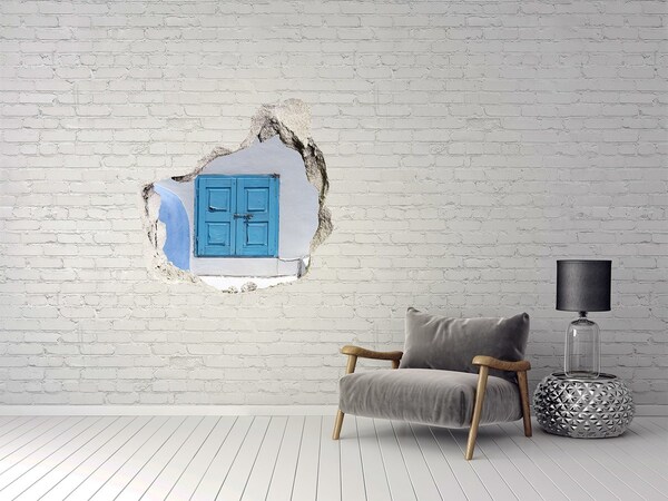 Sticker mural effet trou Un mur délabré avec une porte bleue