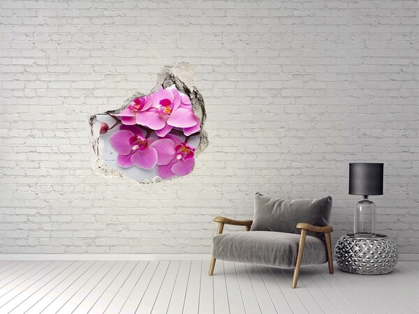 Sticker mural effet trou Des orchidées fleurissent à travers un trou dans le mur