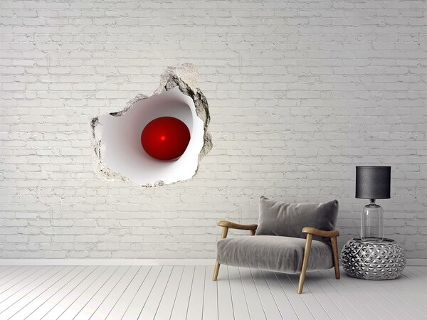 Autocollant mural trou Boule rouge dans un trou dans le mur