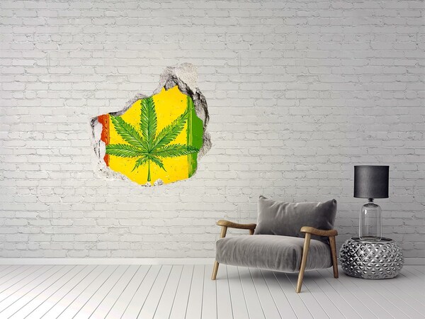 Sticker trou dans le mur Feuille de cannabis verte sur fond jaune-rouge-vert