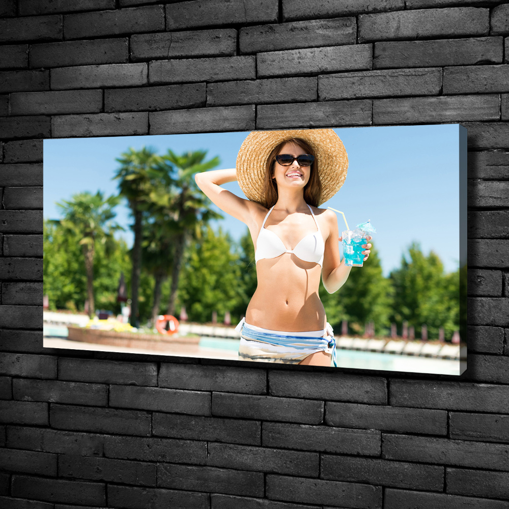 Tableau mural sur toile Femme au bord de la piscine