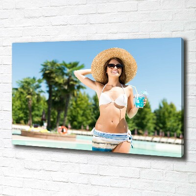 Tableau mural sur toile Femme au bord de la piscine