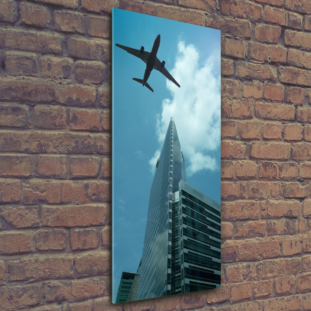 Tableau imprimé sur verre Avion au-dessus de la ville