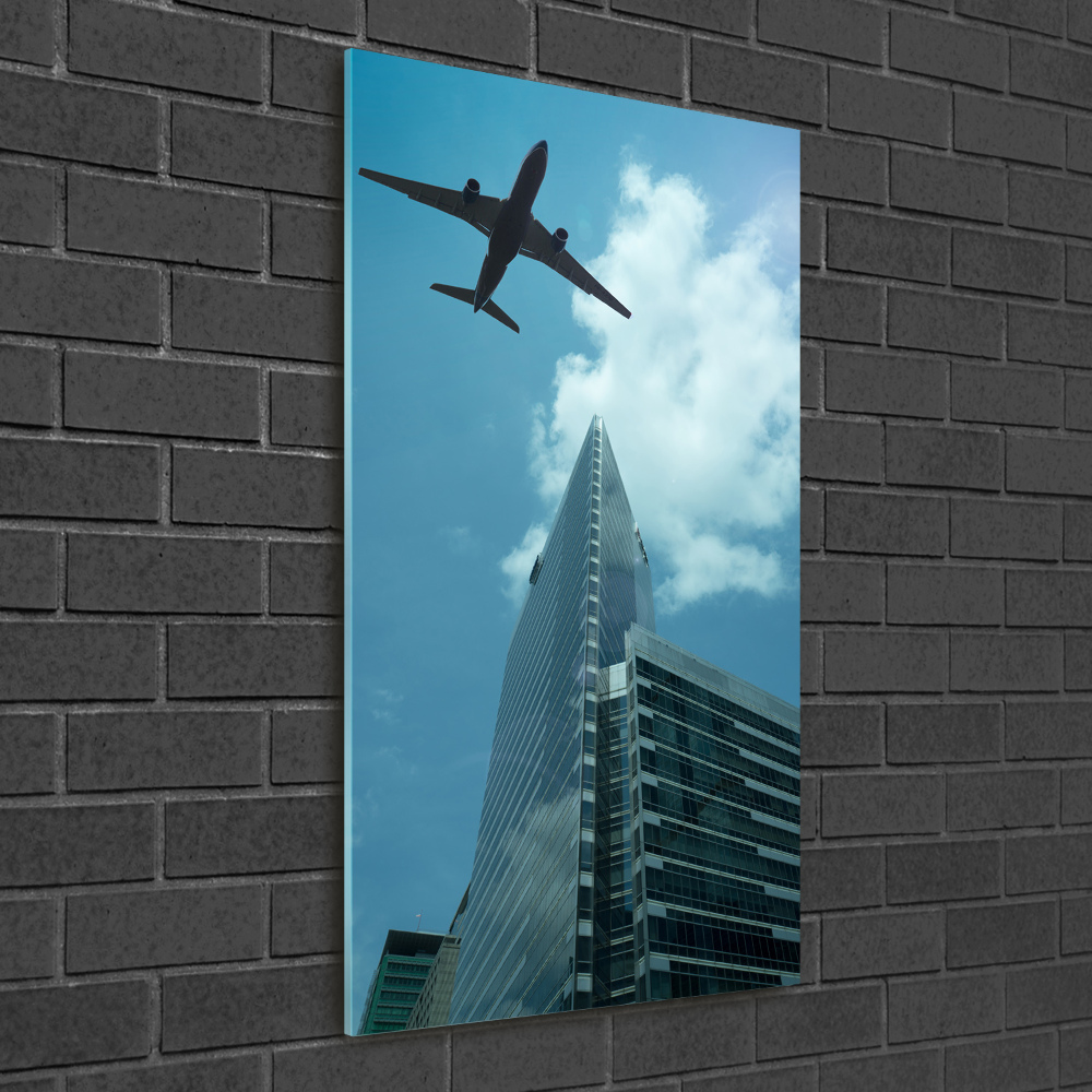 Tableau imprimé sur verre Avion au-dessus de la ville