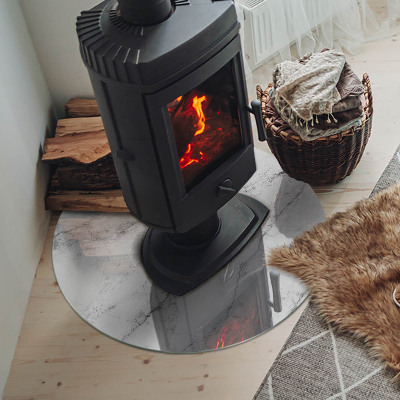Plaque de sol ronde en verre cheminée accents de marbre aux veinures délicates