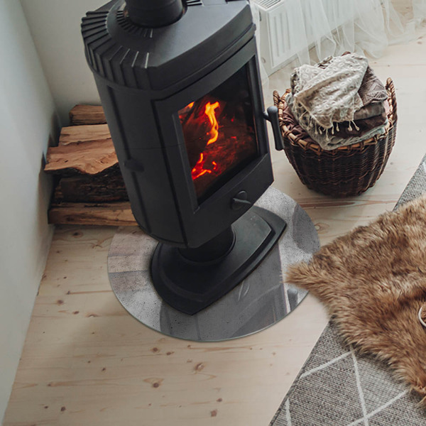 Plaque verre ronde sous poêle structure en béton brut